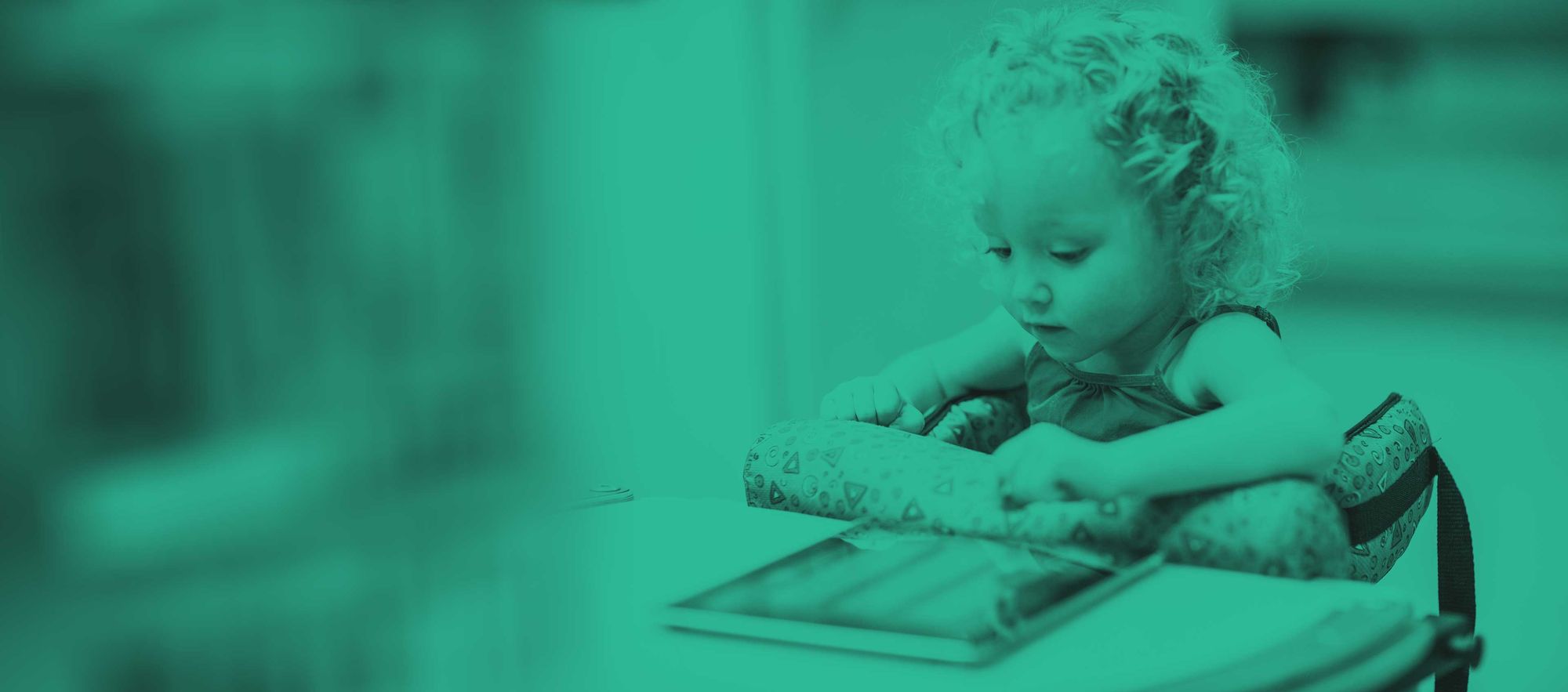 Little girl working on an iPad.